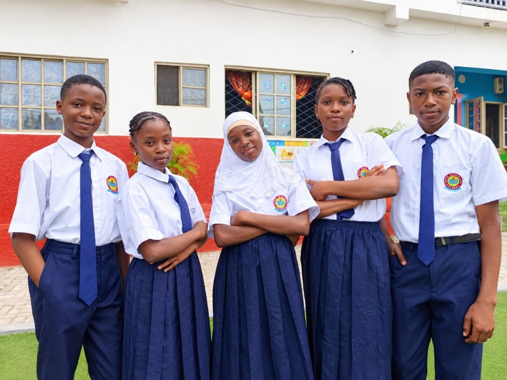 Secondary pupils in white shirts, navy ties, and navy uniform